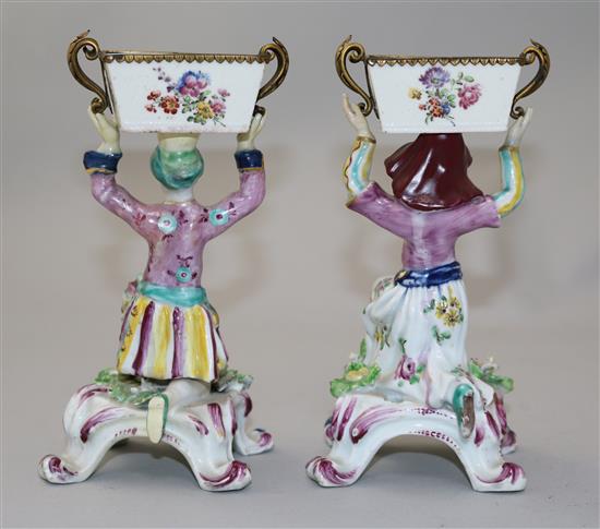 A pair of Bow figural sweetmeat dishes, c.1765-70, height 17cm, restorations